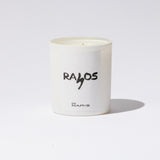 White candle with 'RAIOS' branding on a white background
