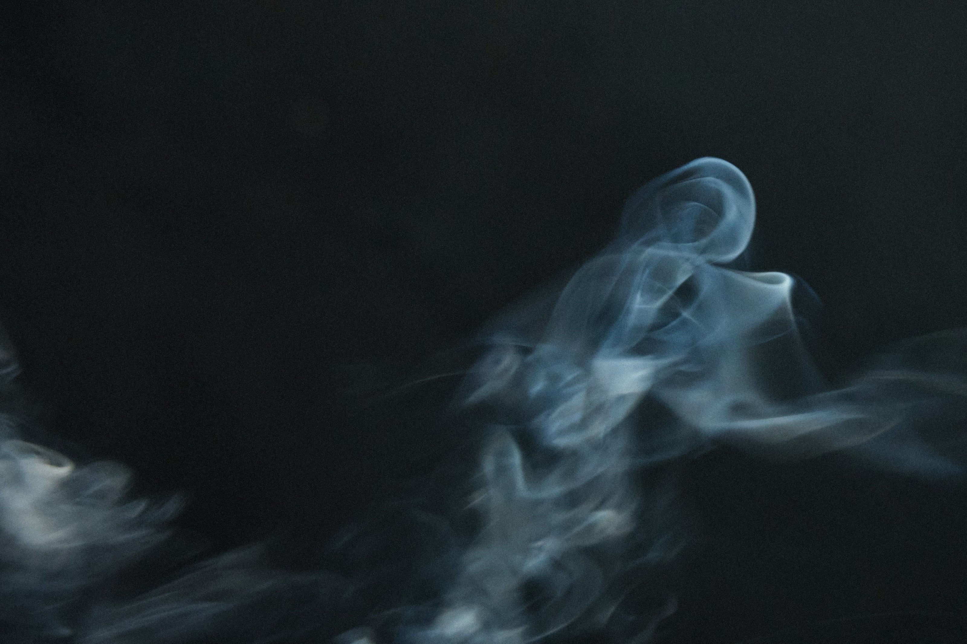 White smoke or fog against a black background