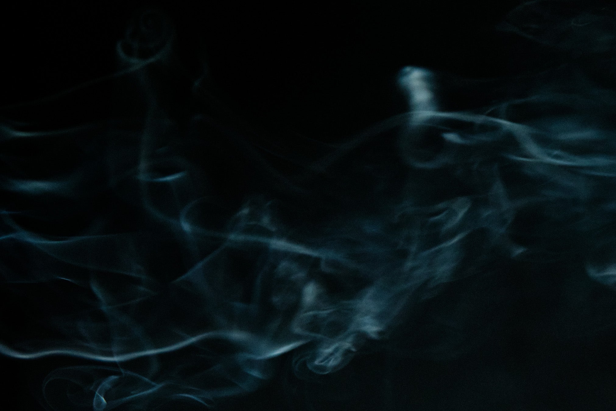 Blue smoke or fog effect on a black background