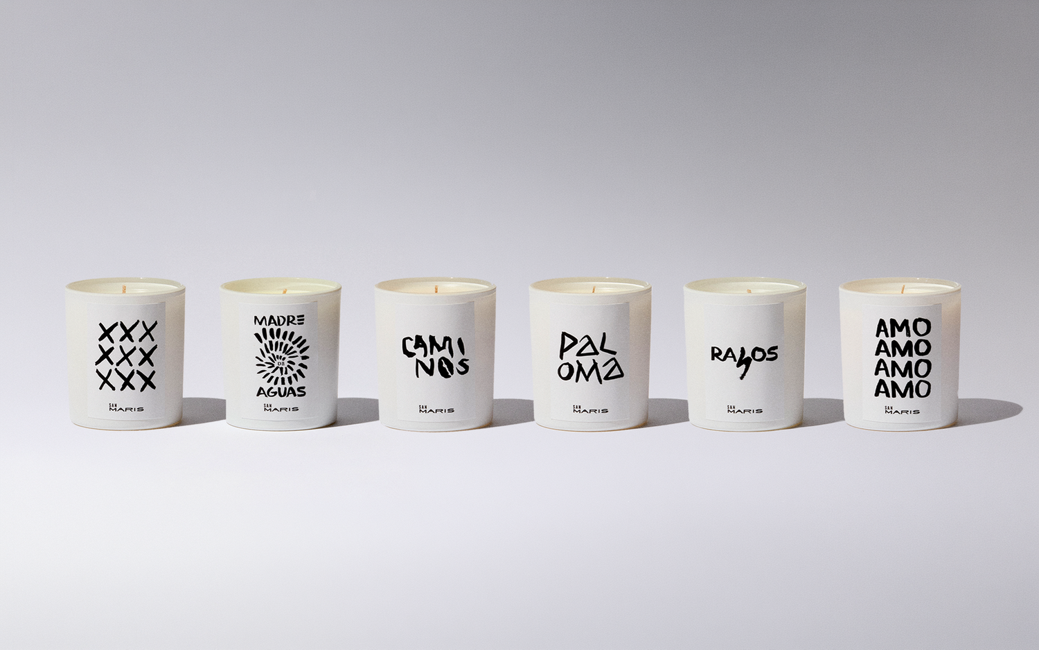 Six white candles with black text on a gray background