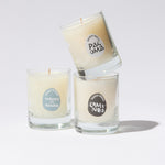 Three glass candles with labels on a white background