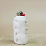 White textured lighter case with a red accent on a beige background