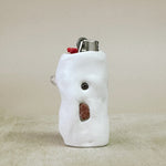 White shaped lighter on a beige surface