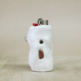 White shaped lighter on a beige surface