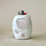 White ceramic lighter on beige back drop with Rose Quartz