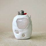White ceramic lighter on beige back drop with Rose Quartz