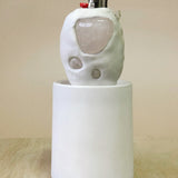 Ceramic lighter ceremonial object  on a beige surface