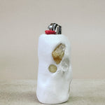 Lighter with decorative stones on a beige surface