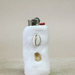 Lighter case with shells on a beige background