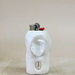 White ceramic object lighter on a beige surface