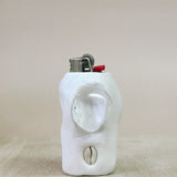 White ceramic object lighter on a beige surface