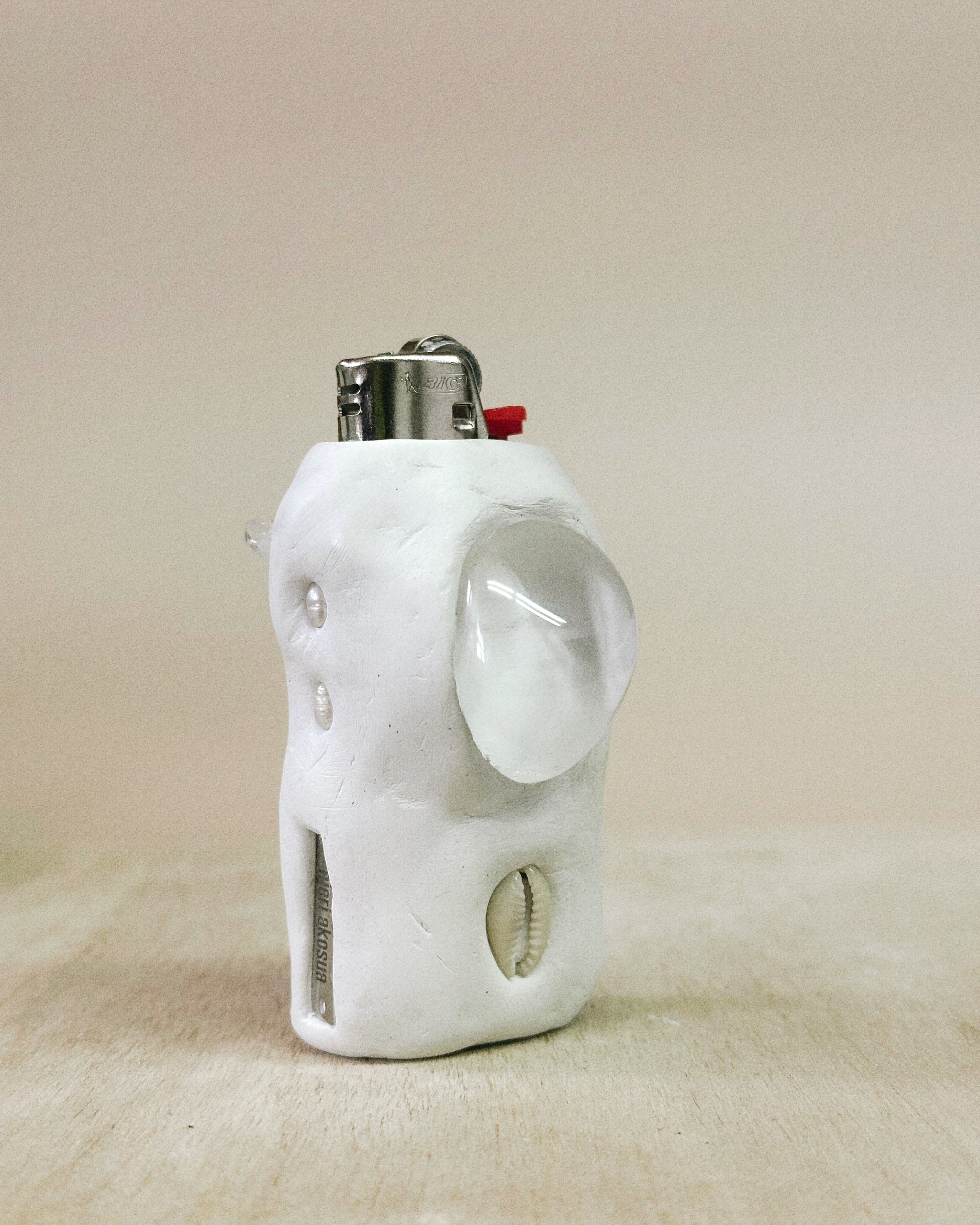 White shaped lighter on a beige background