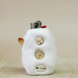 White ceramic lighter with shell designs on a beige background