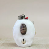 White lighter with a shell design on a beige background