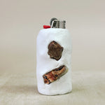 White lighter with carnelian accents on a beige background
