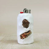 White lighter with carnelian accents on a beige background