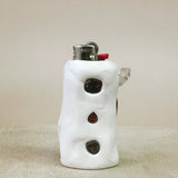 White ceramic lighter with black and red accents on a beige surface
