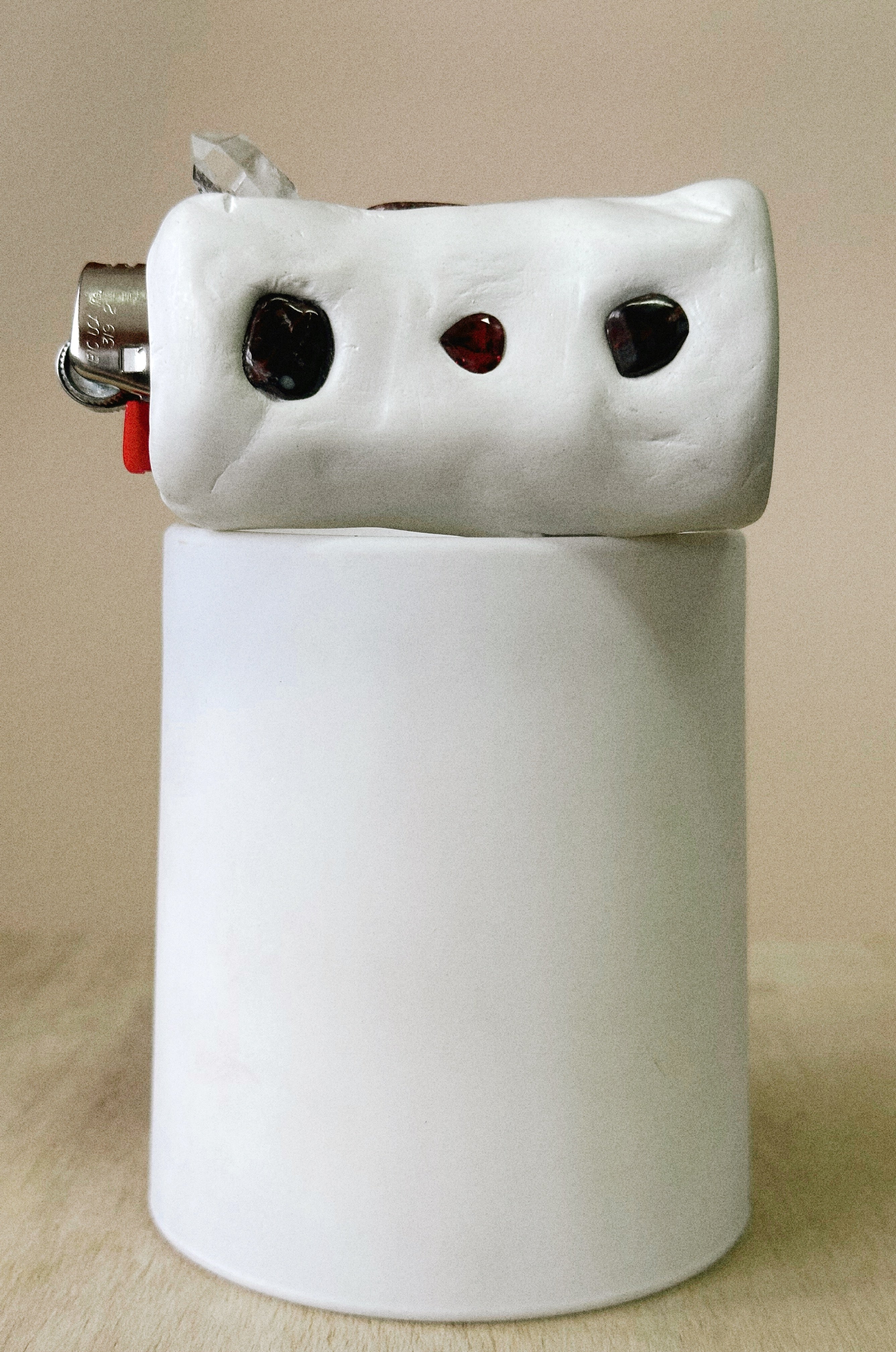 White ceramic light object on candle on a beige background