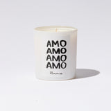 White candle with 'AMO AMO AMO AMO' text on a white background