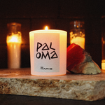 paloma candle sitting on a altar