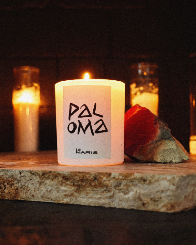 paloma candle sitting on a altar
