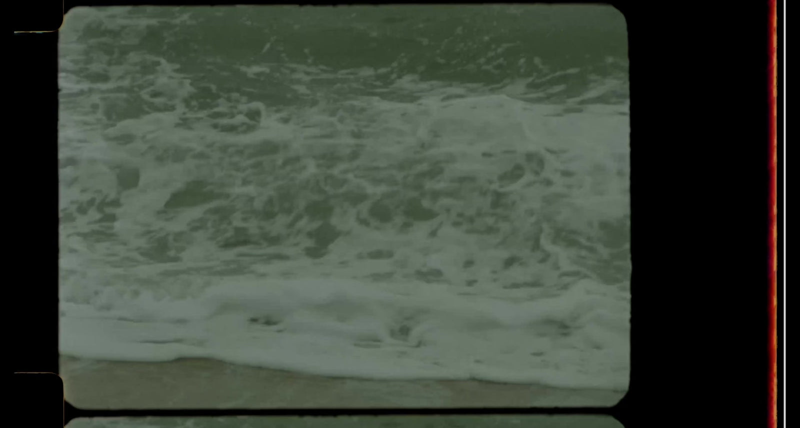 Video of the ocean and a girl walking on the beach, roses in the sand and Madre de Aguas candle burning on a rock