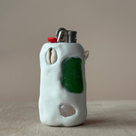 Ceramic lighter with green seaglass accent on a neutral background