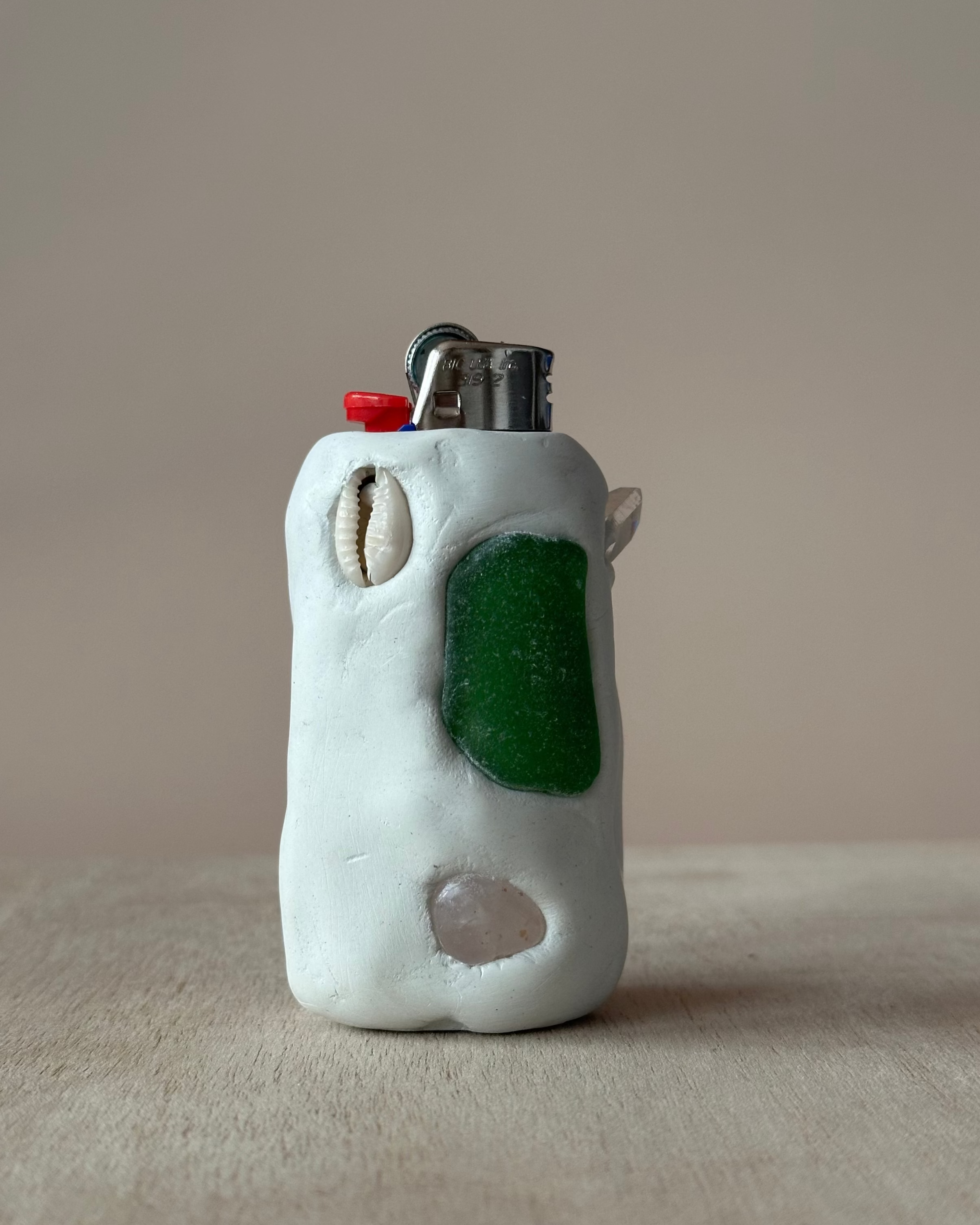 Ceramic lighter with green seaglass accent on a neutral background